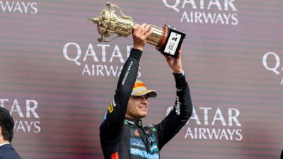 Lando Norris of the United Kingdom and Team McLaren holds up a trophy to celebrate his win at Silverstone on 6 July 2025