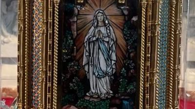 A close-up of the reliquary with an image of the Virgin Mary