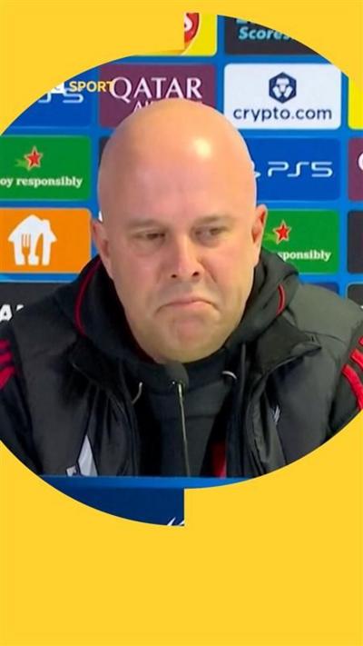 Arne Slot frowns in a press conference