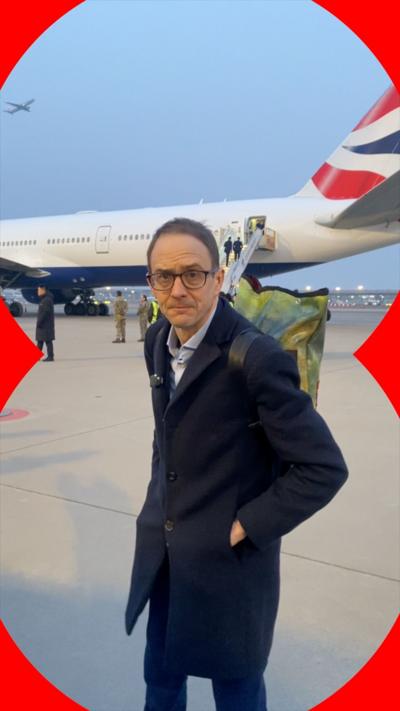 A man, Chris Mason, in front of an airplane.
