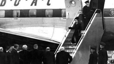 Queen Elizabeth disembarking a plane on her return to the UK.