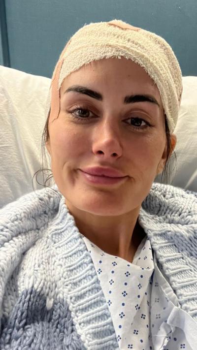 Lauren Macpherson in hospital with a bandage on her head