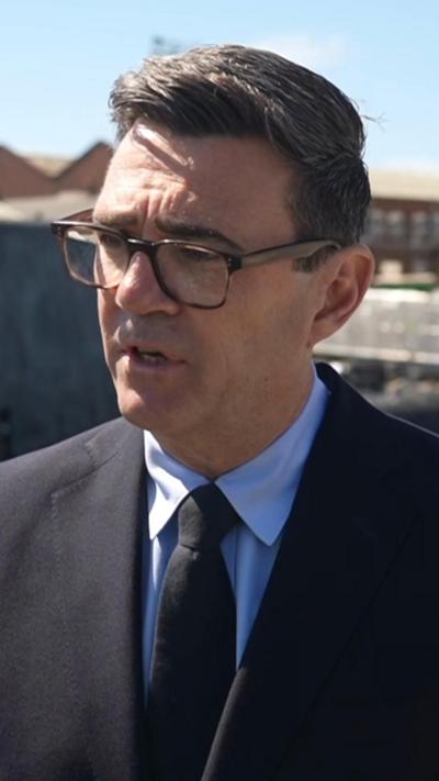Andy Burnham wears a black suit