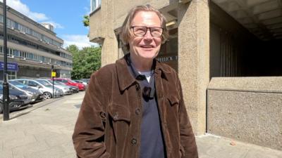 Robert Elms standing outside Trellick Tower