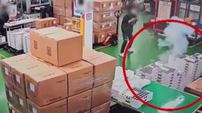 CCTV of battery stacks emitting smoke on factory floor