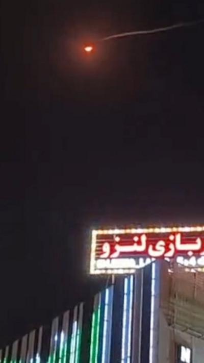 Missile flying over sign during the night 