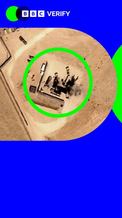 A damaged US anti-air system is seen in a satellite images. It is in a sandy location with clear scorch marks around it. 