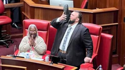Western Australia MP drinking beer out of his shoe in parliament