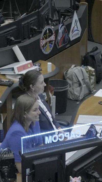 Two women sit at desks