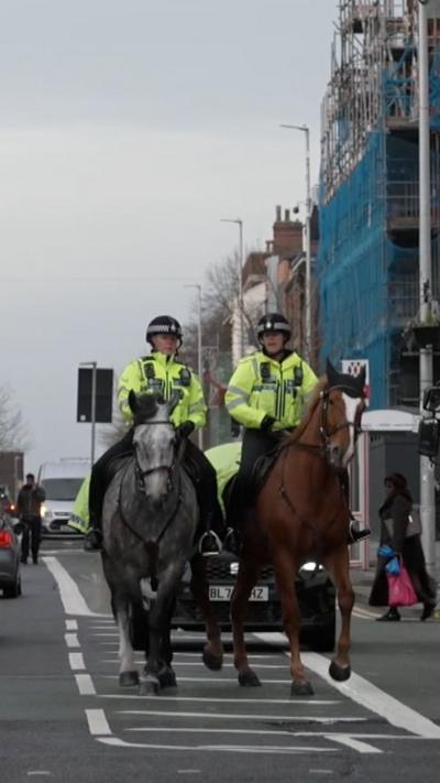Police horses patrolling a high street