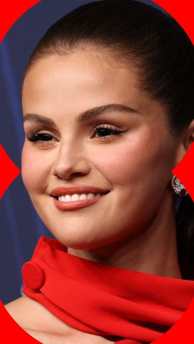 Selena Gomez head shot. She's wearing a red dress.