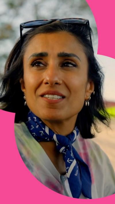 Anita Rani looks to the side with sunglasses on her head 
