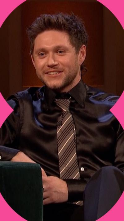 Niall Horan wearing a dark shirt and tie