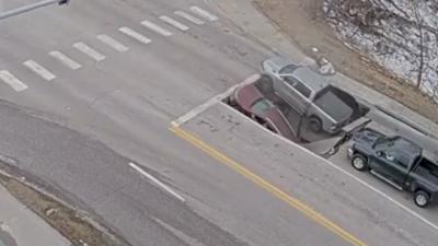 CCTV shows moment cars engulfed by sinkhole