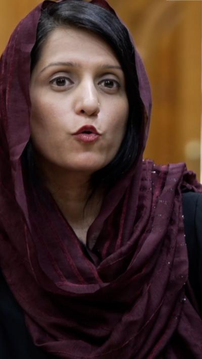 Yogita Limaye wears a purple headscarf.