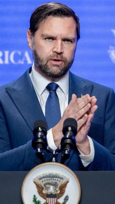 JD Vance at podium in front of blue background