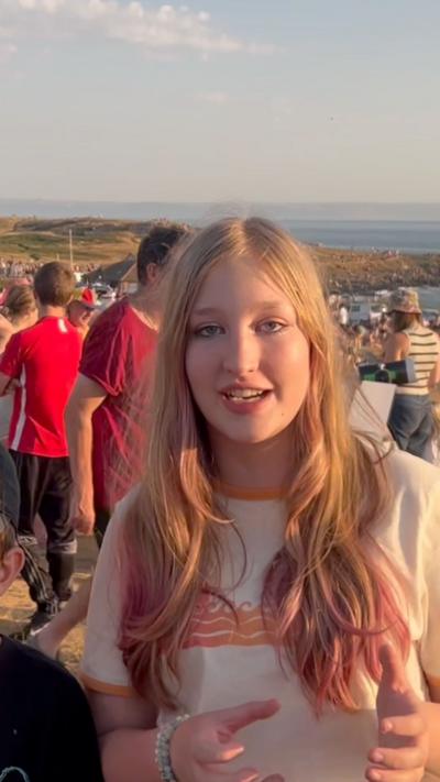 A blonde girl on a crowded beach