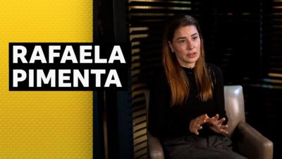 Football agent Rafaela Pimenta sitting in a chair mid interview