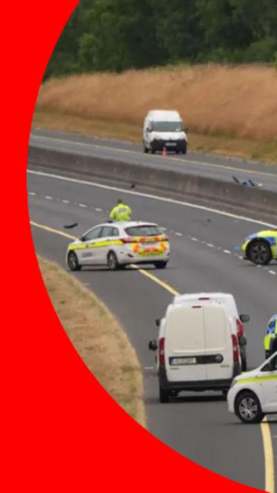 Image of a motorway with Garda vehicles stationary in the middle of the road.