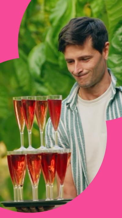 Contestant carrying tray of stacked glasses 