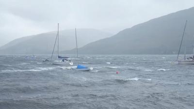 Yachts and fishing boats bob around in stormy seas on Loch Linnhe, western Scotland