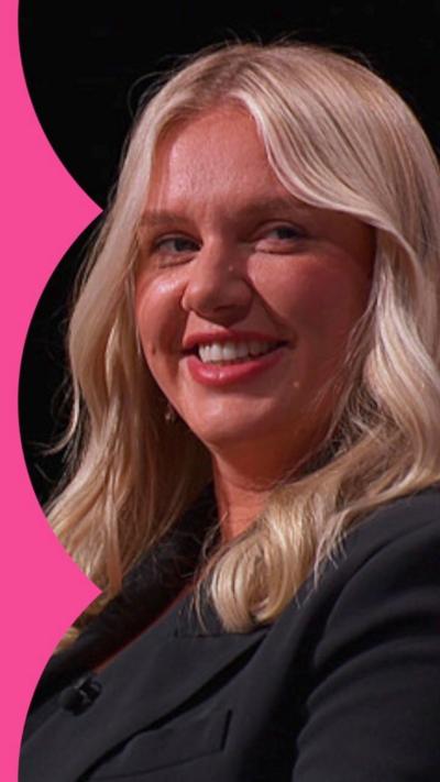 Jenna Meek wearing a black blazer, smiling to her left hand side. She has long blonde hair