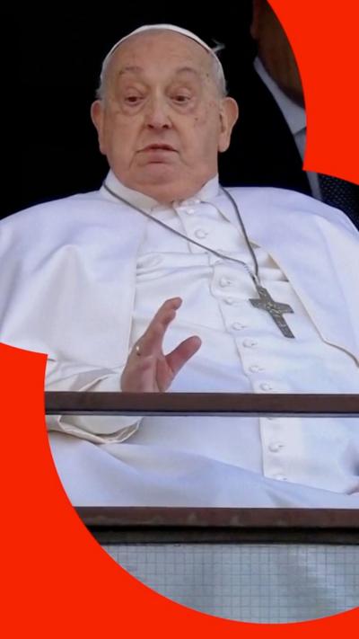 The Pope sits and waves from his hospital window