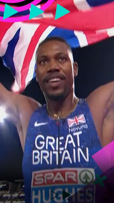 Zharnel Hughes holds the Union Flag above his head