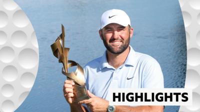 Scottie Scheffler holds up the trophy