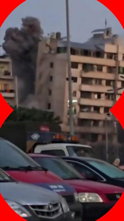 A building collapsing with a plume of smoke in Beirut