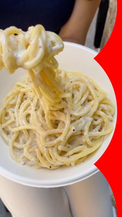 Pasta being lifted from a bowl with a fork