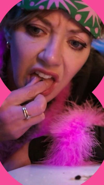 Mandy, wearing a night gown, puts something in her mouth