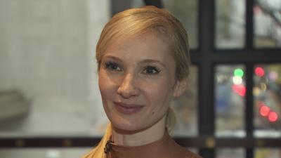 Melissa Hamilton - a woman with long, blonde hair which is tied back in a ponytail is smiling as she looks slightly off camera.