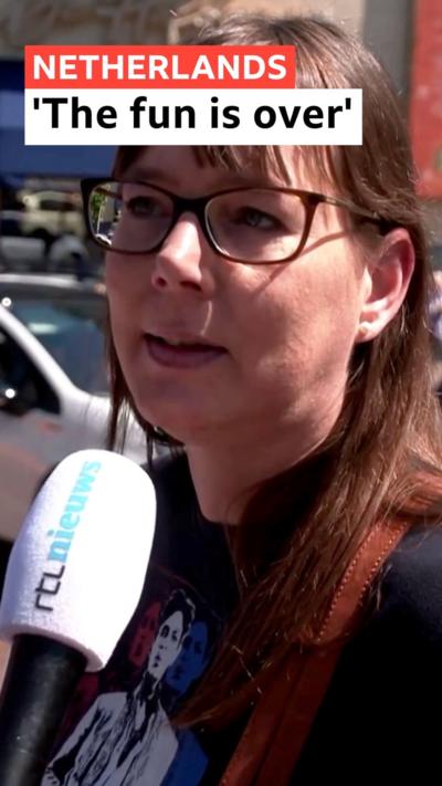 A Dutch woman speaking into a microphone