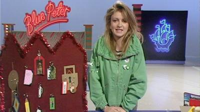 Caron Keating beside keyrings on the Blue Peter set