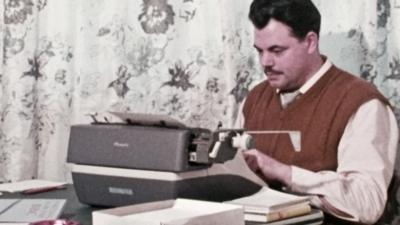 Romantic fiction writer Donald Rowland at his typewriter.