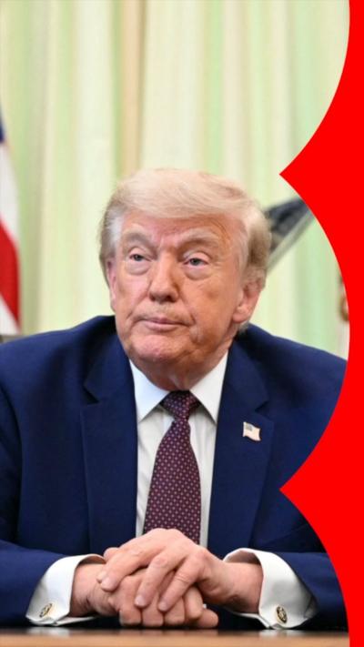 Donald Trump sitting with his hands on top of one another.