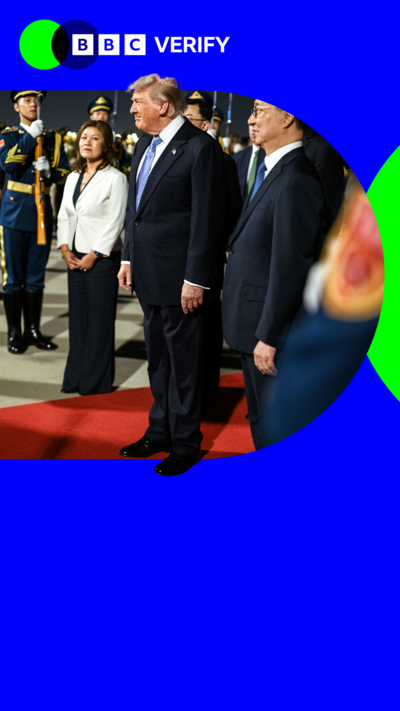 US President Donald Trump standing on a red carpet during his arrival in China.