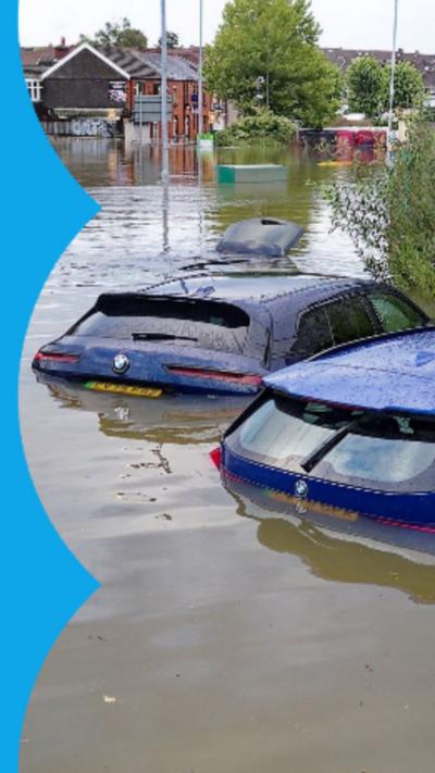 A number of cars submerged in water in a car park