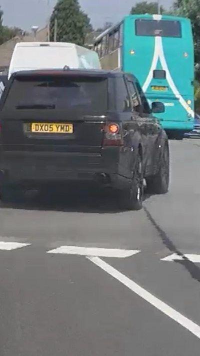 Dashcam screenshot of a black Range Rover