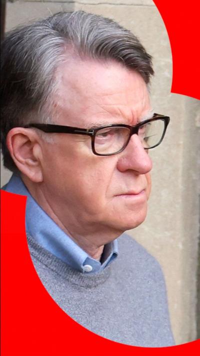 Peter Mandelson seen outside, wearing glasses, a grey jumper, and a blue shirt