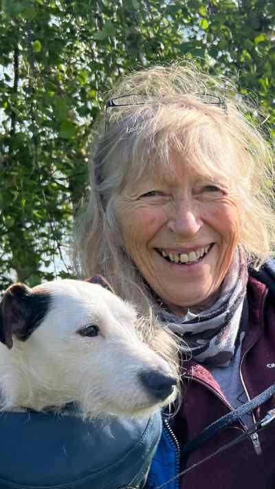 Woman holding missing terrier dog
