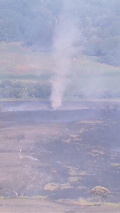Aerial footage from a helicopter shows a dust devil in the distance over New Forest, Hampshire.