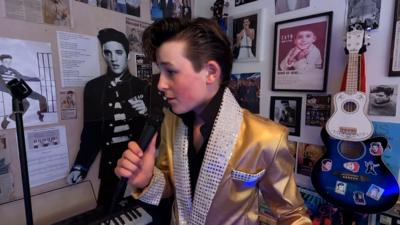 Cooper as Elvis with a microphone