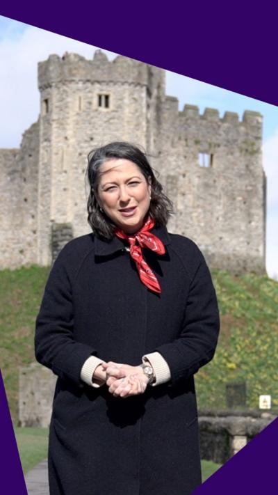 Teleri Glyn Jones speaks to the camera in front of Cardiff Castle.