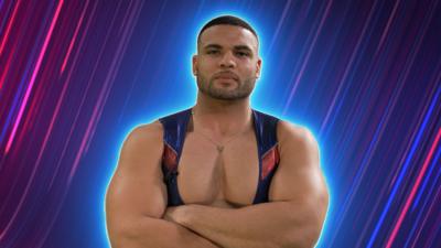 Steel stands with his arms folded in his Gladiator costume