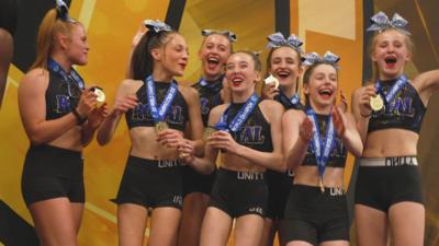 Cheerleaders with winning medals