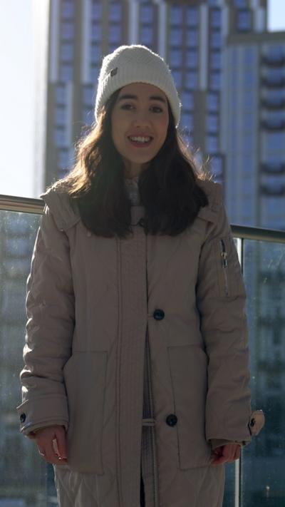 Sabrina Lee in a hat and long coat