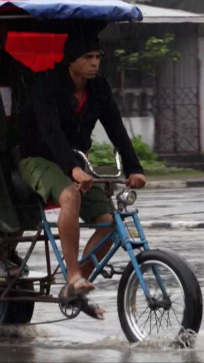Man on bike in rain