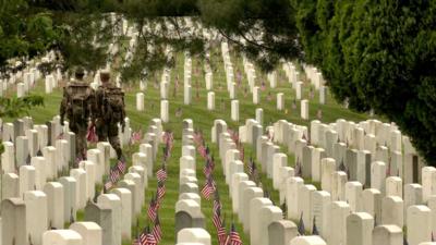 Flags at headstones in Arlington National Cemetary